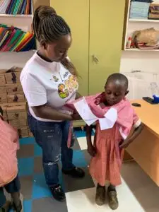 Founder donating School Uniforms